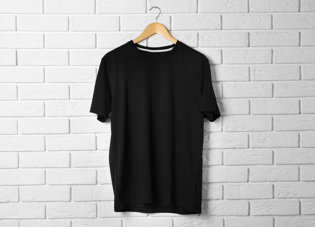 Blank Black T-Shirt against Brick Wall